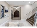 Inviting home entryway features an elegant double door, staircase, and sophisticated décor at 617 Canopy Estates Dr, Winter Garden, FL 34787