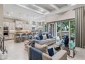Open-concept space combining the living room, kitchen, and dining area with modern furnishings at 617 Canopy Estates Dr, Winter Garden, FL 34787