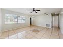 Inviting living room featuring tile flooring, a ceiling fan, and natural light at 624 American Heritage Pkwy, Orlando, FL 32809