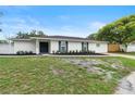 A beautifully renovated single-story home featuring fresh landscaping and a well-maintained lawn at 7446 Houston E Ct, Winter Park, FL 32792