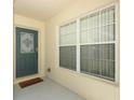 Welcoming front door with decorative glass insert and sidelight window, showcasing a charming entrance at 8093 Indian Creek Blvd, Kissimmee, FL 34747