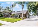 This home includes a spacious driveway, a well-manicured lawn and mature landscaping at 831 Royalwood Ln, Oviedo, FL 32765