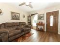 Comfortable living room with a brown sofa, wood-look floors, and natural light at 1078 Aaron Dr, Deltona, FL 32725