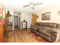 Cozy living room featuring wood-look floors, a ceiling fan and comfortable furnishings at 1078 Aaron Dr, Deltona, FL 32725