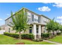 Beautiful exterior of a two-story home with a well-manicured lawn, landscaped yard, and covered front porch at 11054 Hanlon Terrace Aly, Winter Garden, FL 34787