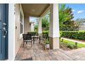 Inviting front porch with stone flooring and outdoor seating, perfect for relaxing at 11054 Hanlon Terrace Aly, Winter Garden, FL 34787