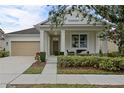 Charming single Gathering home showcasing a well-manicured lawn and a beige two-car garage at 12679 Calderdale Ave, Windermere, FL 34786
