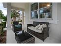 Relaxing porch featuring cozy wicker seating with a glass coffee table and neutral cushions at 12679 Calderdale Ave, Windermere, FL 34786
