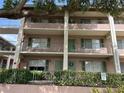Multi-story condo building with balconies, green shutters, and neat landscaping at 145 Oyster Bay Cir # 200, Altamonte Springs, FL 32701