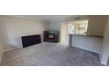 Spacious living area with neutral carpet, modern fireplace, and adjacent kitchen at 145 Oyster Bay Cir # 200, Altamonte Springs, FL 32701