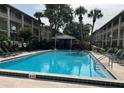 A serene community pool, surrounded by lush landscaping and lounge chairs at 145 Oyster Bay Cir # 200, Altamonte Springs, FL 32701