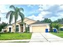 Exterior shot of a charming single-story home with a well-maintained lawn and attached two-car garage at 1672 Canoe Creek Rd, Oviedo, FL 32766
