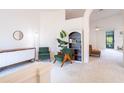 Airy living room with neutral walls, modern decor, arched doorways, and abundant natural light at 1672 Canoe Creek Rd, Oviedo, FL 32766
