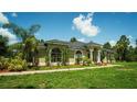 Well maintained home with a walkway, lush landscaping, manicured lawn, and symmetrical facade at 19951 Quinlan St, Orlando, FL 32833