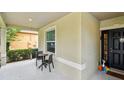 Inviting front porch with outdoor seating and a view of the landscaped front yard at 2409 Martins Run, Tavares, FL 32778