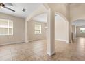 Spacious living room featuring tile floors, neutral walls, and elegant archways at 3578 Cortland Dr, Davenport, FL 33837