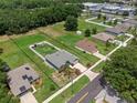 Aerial view of home in Umatilla with lawn, privacy fence, and surrounding greenery at 382 Lake St, Umatilla, FL 32784