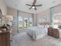 Cozy bedroom with plush carpeting, neutral walls, and elegant furniture at 4413 Lions Gate Ave, Clermont, FL 34711