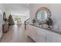 Bright entryway with elegant console table, decorative mirror, and views into a cozy living area at 4413 Lions Gate Ave, Clermont, FL 34711