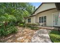 Beautiful entryway with a stone walkway and well-maintained landscaping at 489 Penny Ln, Maitland, FL 32751