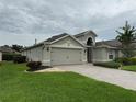 A well-kept home with a two-car garage, green lawn, and neat landscaping in a quiet neighborhood at 541 Arena Dr, Davenport, FL 33837