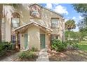 Charming townhome with well-maintained grounds, lush greenery, and a welcoming facade at 5436 E Michigan St # 7, Orlando, FL 32812