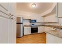Bright kitchen with white cabinets, stainless steel appliances, and granite countertops at 5500 Metrowest Blvd # 203, Orlando, FL 32811