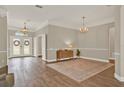 Spacious living room showcasing hardwood floors, neutral walls, and an abundance of natural light at 6321 Clearmeadow Ct, Windermere, FL 34786