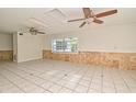 Bright living room with tile flooring, ceiling fans and ample natural light from large windows at 637 15Th St, Debary, FL 32713