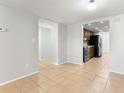 Open kitchen and dining area with tiled floor and modern appliances at 818 Park Lake Cir # 10, Maitland, FL 32751