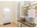 Welcoming foyer with neutral tones, decorative mirrors, console table and tile flooring at 8801 Corcovado Dr, Kissimmee, FL 34747