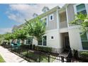 Charming townhouse with a welcoming entrance, a black fence and beautiful trees at 922 Wild Date Ln, Lake Mary, FL 32746
