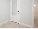 Hallway featuring a full glass door and bathroom with tub at 922 Wild Date Ln, Lake Mary, FL 32746