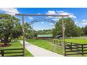 Picturesque entry gate to 'Morning Star Stables' with wooden archway at 12434 Sullivan Rd, Clermont, FL 34715