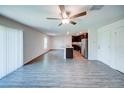 Bright, open-concept living space with wood-look floors and a kitchen featuring a granite island at 1303 Congo Ct, Kissimmee, FL 34759