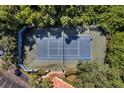 Aerial shot of a well-maintained tennis court surrounded by lush greenery, providing a private playing experience at 1400 Lake Shadow Cir # 10104, Maitland, FL 32751
