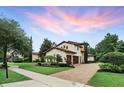 Beautiful two-story home boasts a tile roof, lush landscaping, and an attached two-car garage at 1425 Dunbrooke Loop, Longwood, FL 32779