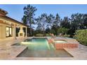 Relaxing pool and spa with tiled accents, surrounded by manicured landscaping and comfortable seating at 1425 Dunbrooke Loop, Longwood, FL 32779