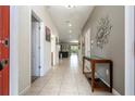Inviting hallway with tiled flooring and stylish decor leading to the home's interior spaces at 1439 Moon Valley Dr, Davenport, FL 33896