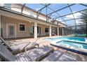 Relaxing screened-in pool area with lounge chairs, offering a perfect outdoor retreat at 1439 Moon Valley Dr, Davenport, FL 33896