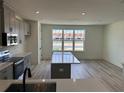 Modern kitchen with stainless steel appliances, gray cabinets, quartz countertops and a center island at 15107 Grove Lake Dr, Winter Garden, FL 34787