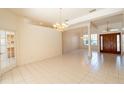 Bright, open living room with tile floors, large windows, and classic chandeliers, perfect for entertaining at 1586 Antoinette Ct, Oviedo, FL 32765
