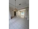 Open-concept living room featuring tile floors and decorative lighting fixtures at 1586 Antoinette Ct, Oviedo, FL 32765