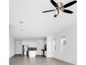 Open-concept living area with lots of natural light, neutral paint colors, and a ceiling fan at 1596 Contentment Loop, Kissimmee, FL 34744