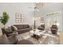 Airy living room with vaulted ceiling, plush rug, and comfortable seating arrangement at 1705 Saint Tropez Ct, Kissimmee, FL 34744