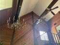 Living room with a vaulted ceiling, exposed beams, and a chandelier at 17952 Lookout Hill Rd, Winter Garden, FL 34787