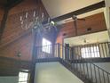 Open living room with a vaulted ceiling, chandelier, and a cozy fireplace at 17952 Lookout Hill Rd, Winter Garden, FL 34787