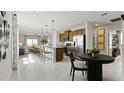 Open-concept kitchen and living area with a large island, stainless steel appliances, and modern pendant lighting at 1916 Diamond Head Cir, Lake Hamilton, FL 33851