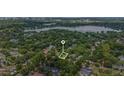 Stunning aerial view of the property, highlighting its lush surroundings, and proximity to a lake at 1961 Winter Park Rd, Winter Park, FL 32789