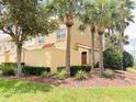 Charming townhome with mature palm trees, green lawns and lush landscaping at 2404 Bella Vista Dr, Davenport, FL 33897